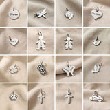 Keyring charms selection showing symbols including hearts, crosses and decorative charm designs