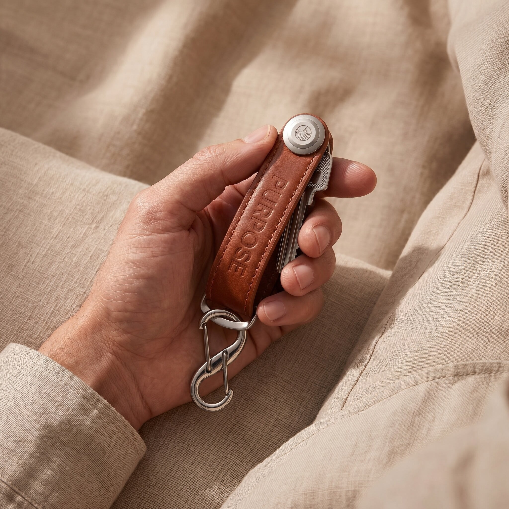 Hand holding leather key organizer, compact key holder for organised everyday carry