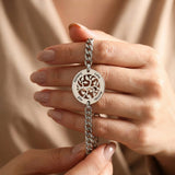 Belle Fever family tree bracelet close-up, custom engraved tree of life pendant bracelet, personalised family name jewellery, sentimental gold keepsake gift for her.