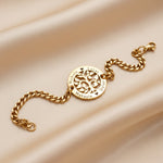 Belle Fever my tree bracelet gold macro flat lay, custom engraved name bracelet, symbolic tree of life jewellery gift, elegant personalised family keepsake.