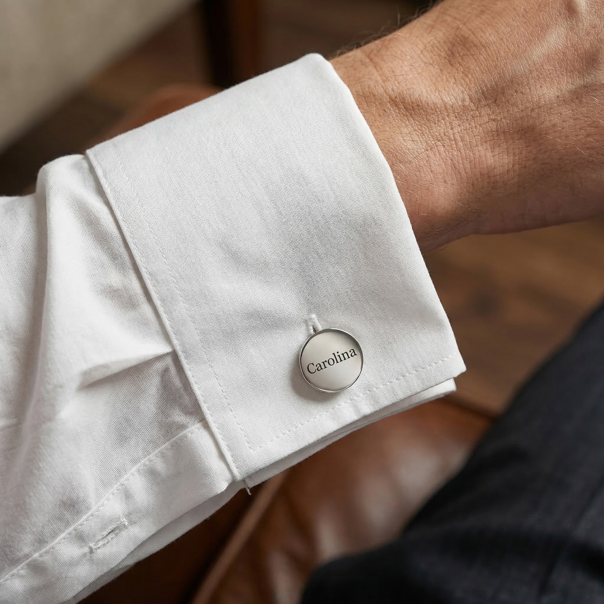 Man wearing personalised cufflinks with engraved name on shirt cuff, formal lifestyle image