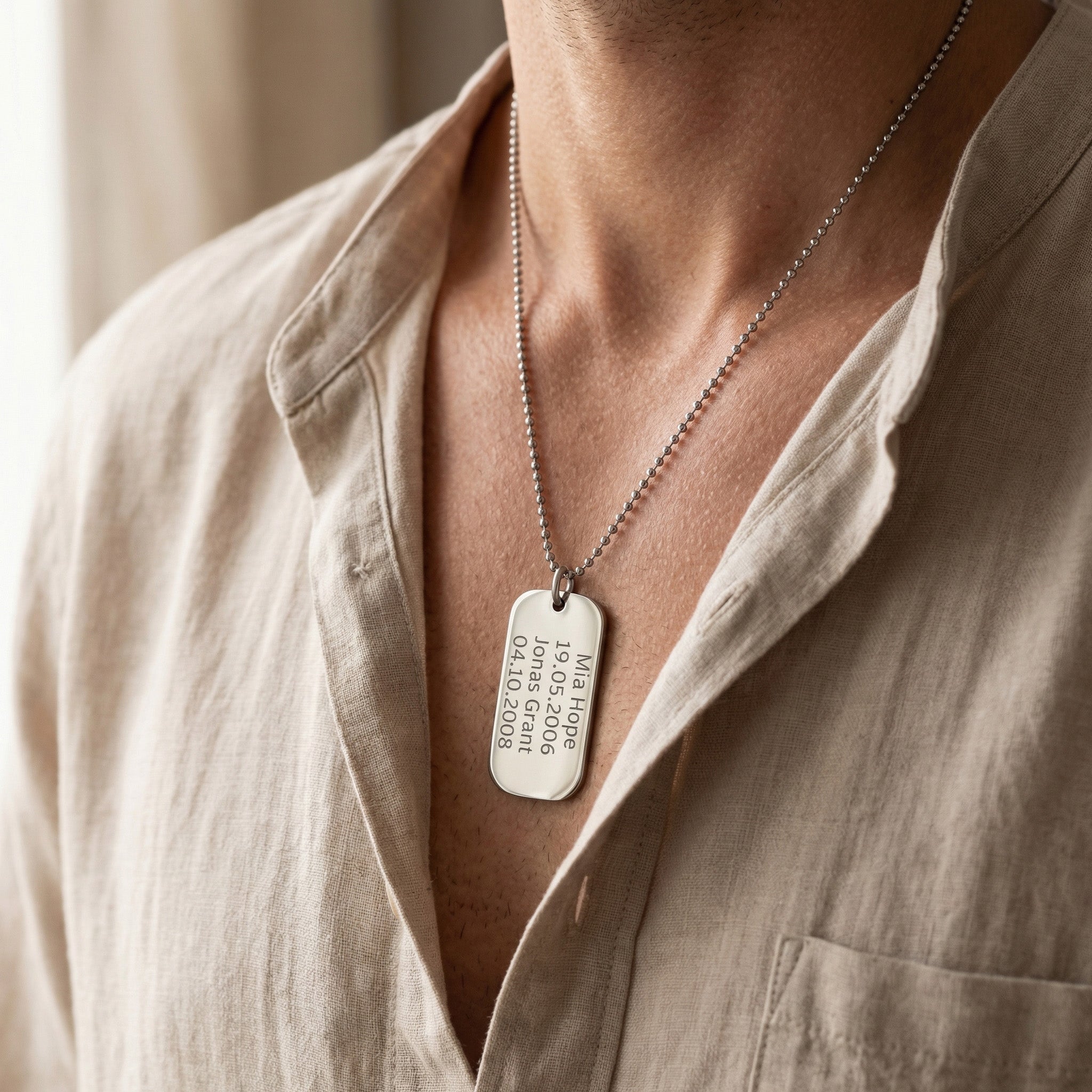 Man wearing personalised dog tag necklace with engraved message, meaningful jewelry lifestyle image