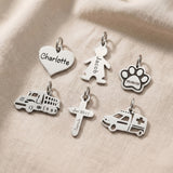 Personalised keyring charms in silver showing engraved name charms and symbol options