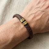 Personalised brown leather bracelet with engraved gold charms, custom design option