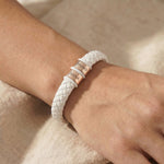 Personalised white leather bracelet with silver engraved name charms, modern custom jewellery option