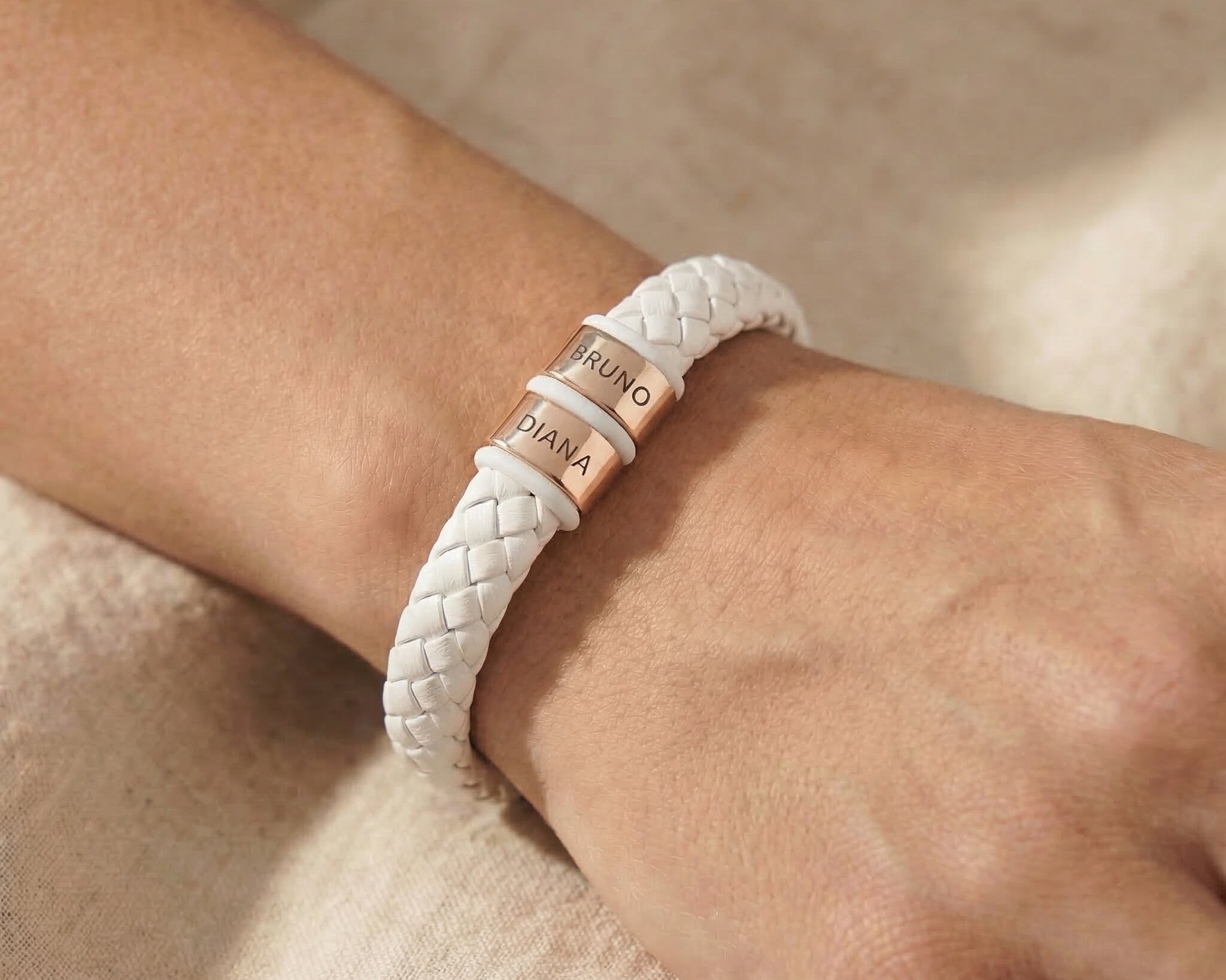 Personalised white leather bracelet with silver engraved name charms, modern custom jewellery option