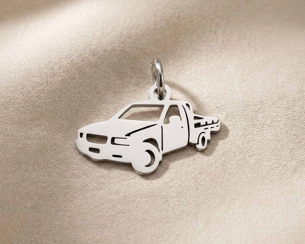 Silver pickup truck charm for keyring symbolizing adventure, road trips, and hardworking lifestyle memories
