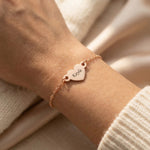 Woman wearing personalised heart bracelet with engraved name, minimal everyday style