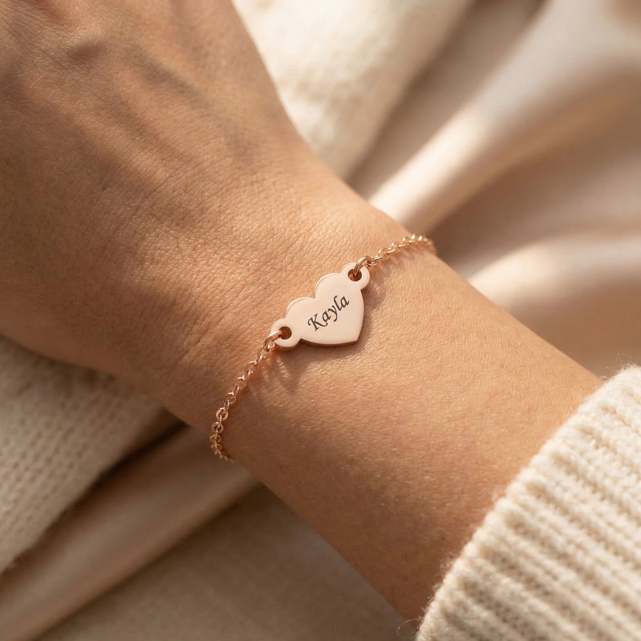 Woman wearing personalised heart bracelet with engraved name, minimal everyday style