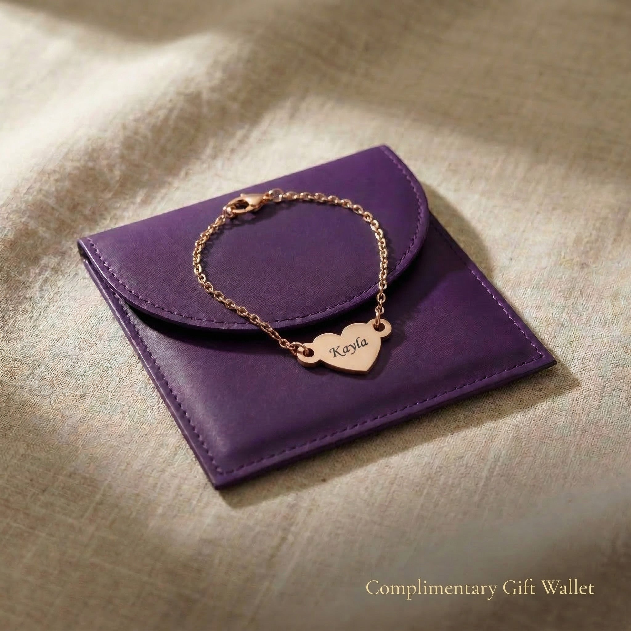 Personalised heart bracelet with engraved name displayed with gift wallet packaging