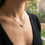 Woman wearing personalised heart necklace with engraved name, minimal everyday style