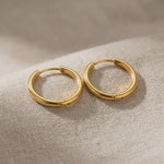 Product video showing chic sleeper hoop earrings with classic round hoop design