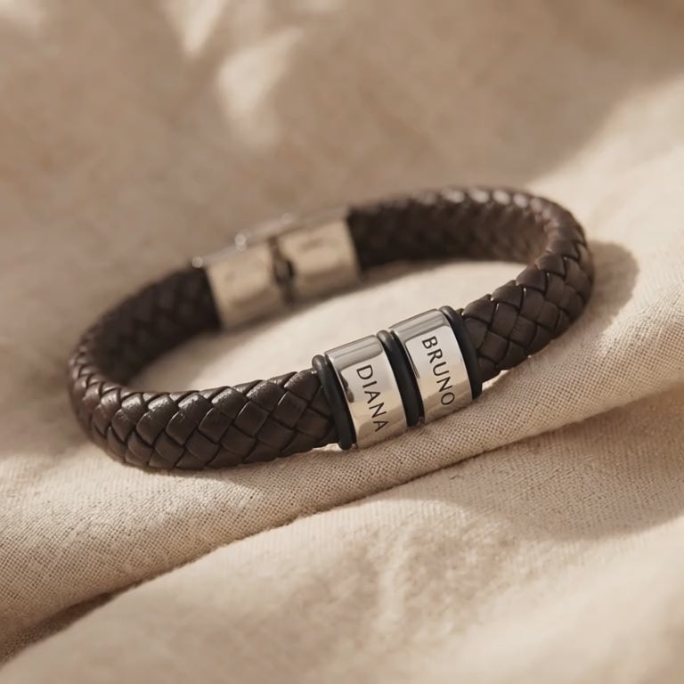 Video showing personalised leather bracelet with engraved name charms and braided detail