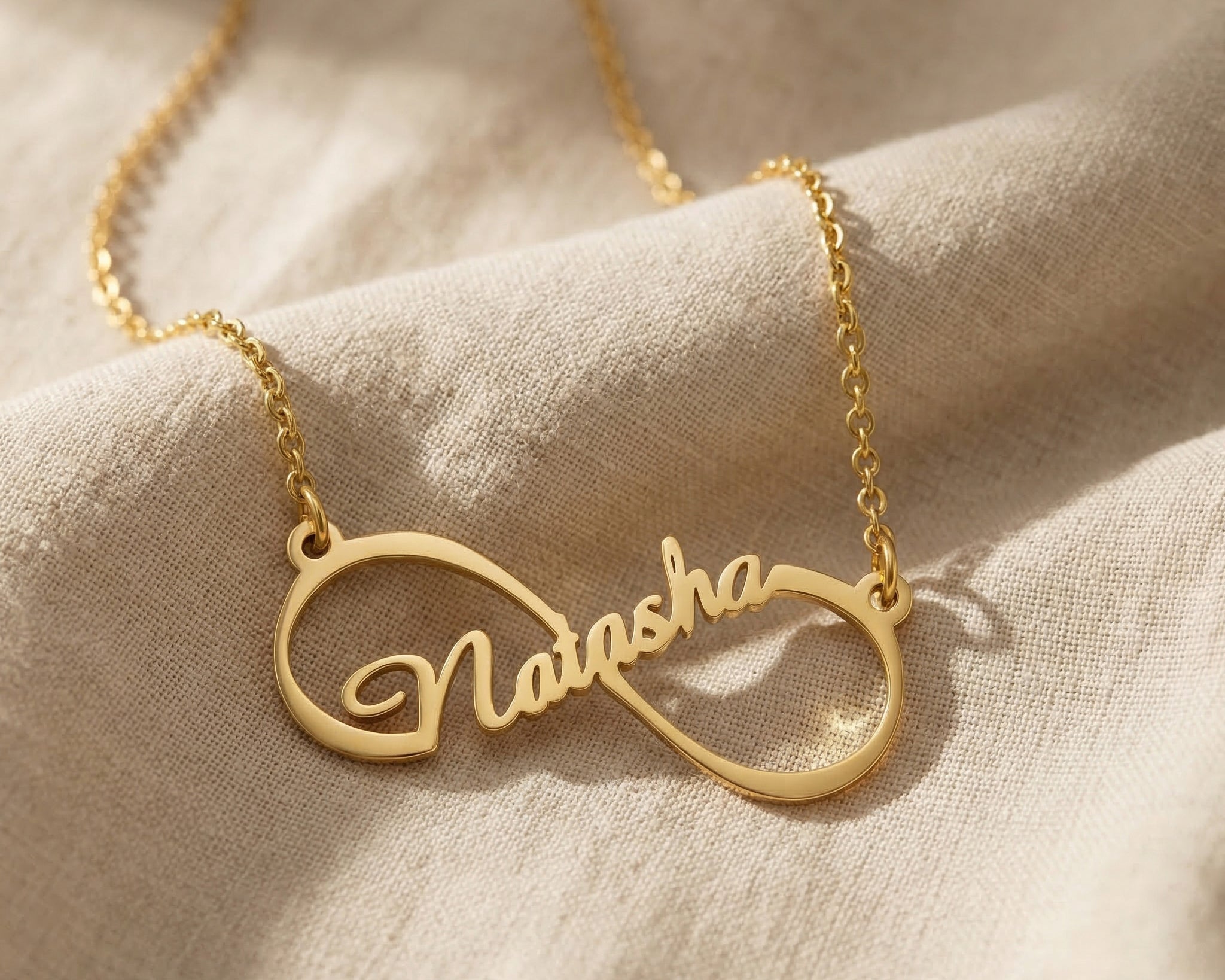Single infinity name necklace in gold with personalised name, elegant everyday jewellery