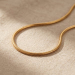 Snake chain necklace in gold with sleek flat chain design, minimalist jewellery for lpendant and everyday wear