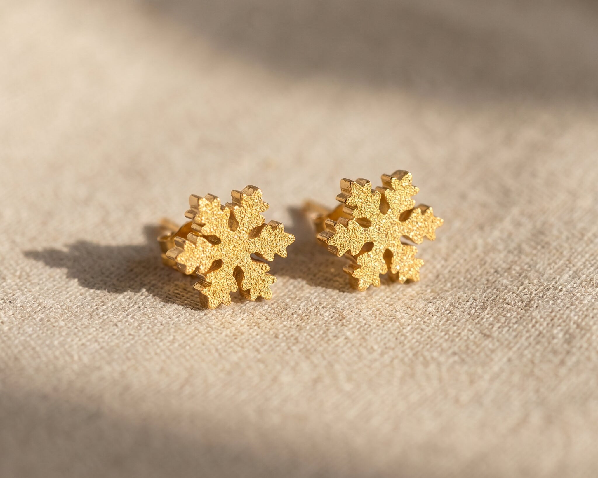 Sparkling snowflake earrings in gold with crystal detail, delicate festive jewellery gift idea