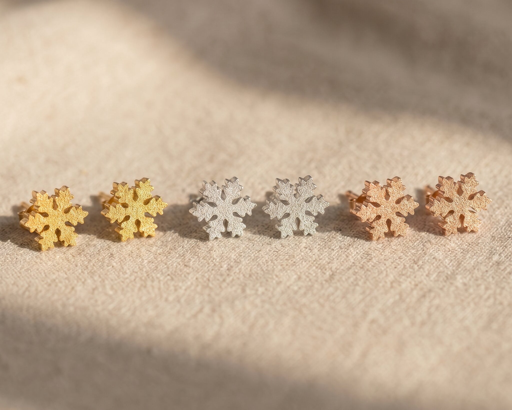 Sparkling snowflake earrings tone comparison showing gold, silver and rose gold winter jewellery options