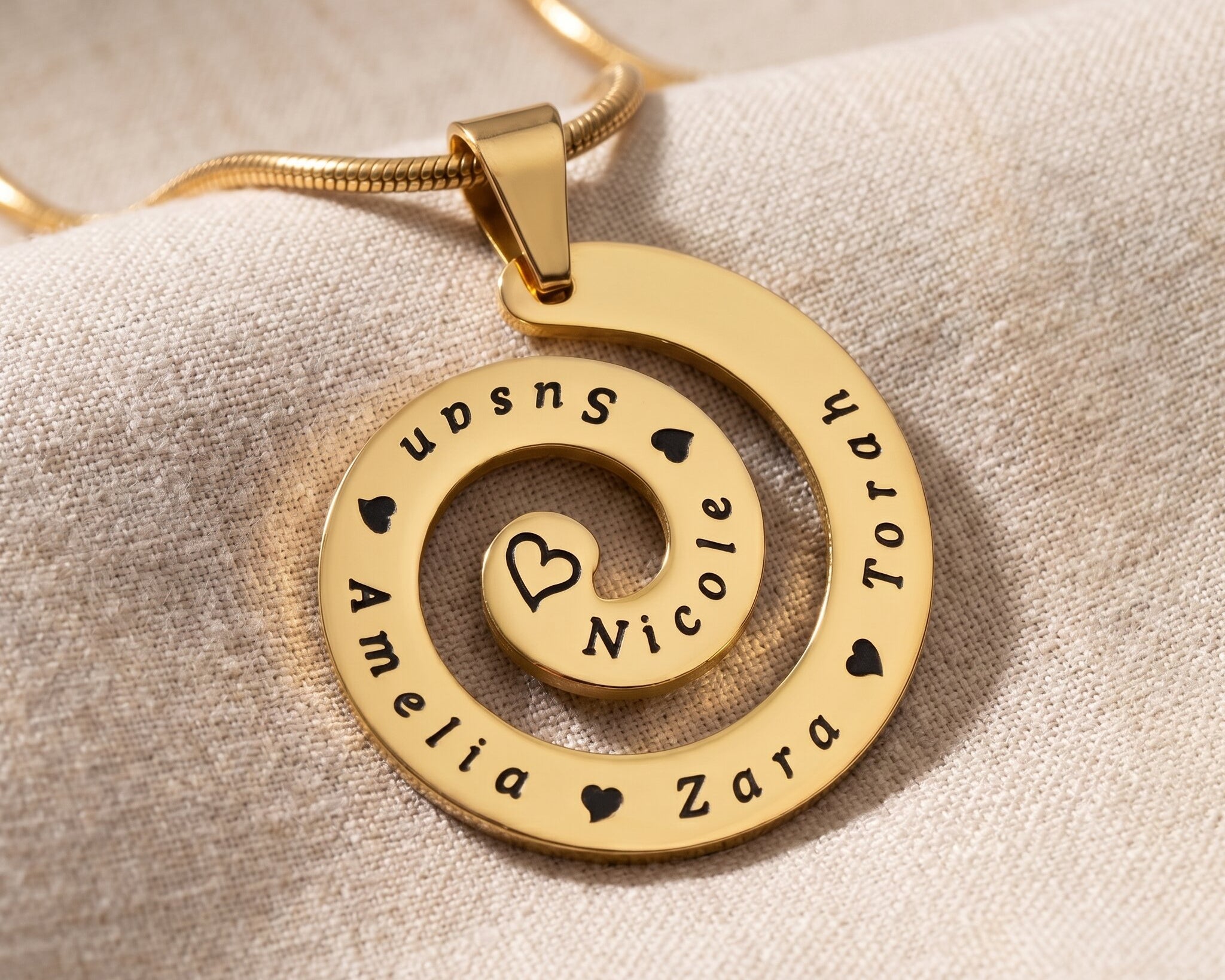 Swirl of time necklace in gold with engraved symbolic design, meaningful keepsake jewellery gift