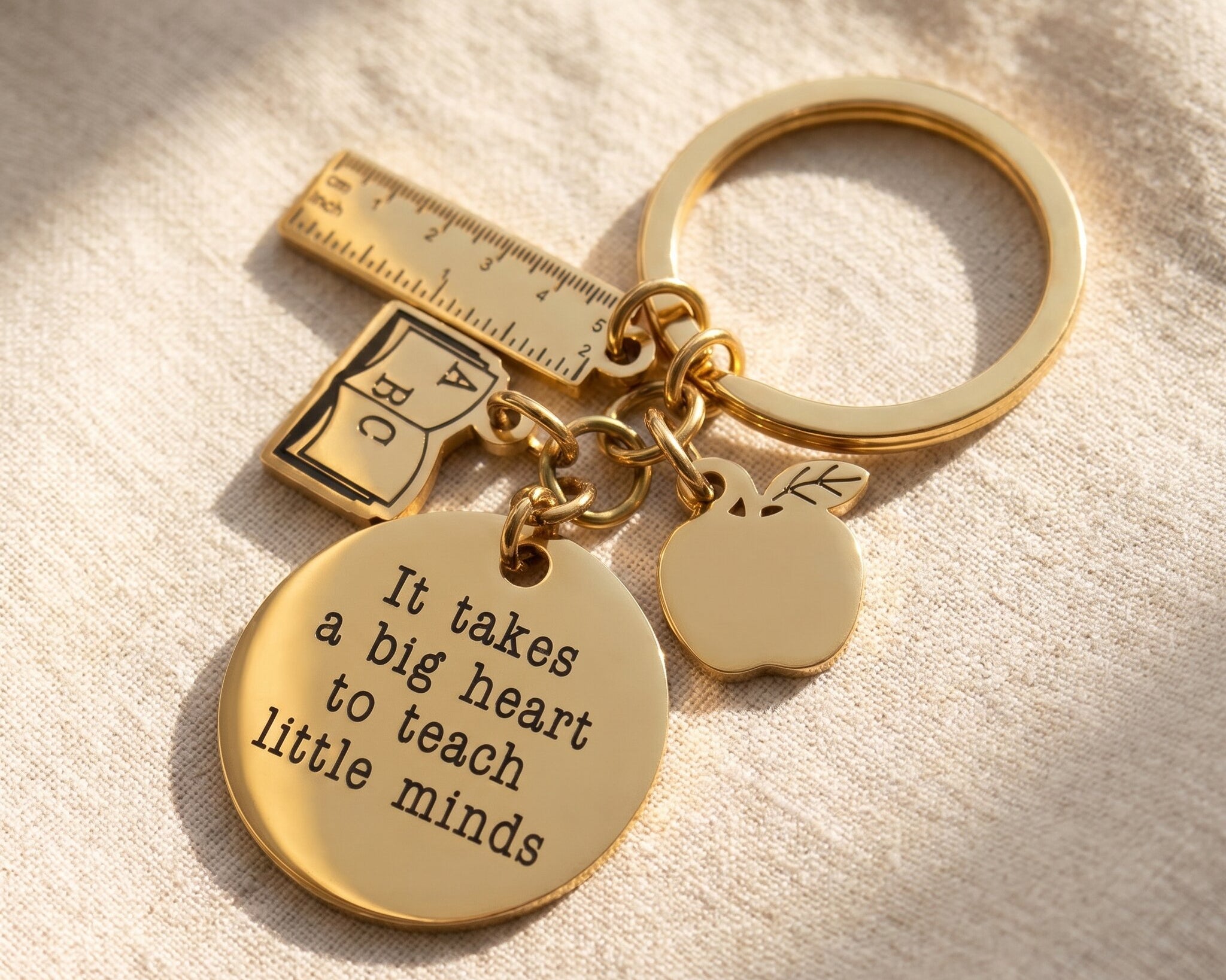 Teacher life keyring in gold with engraved message, book, ruler and apple charm, thoughtful teacher appreciation gift