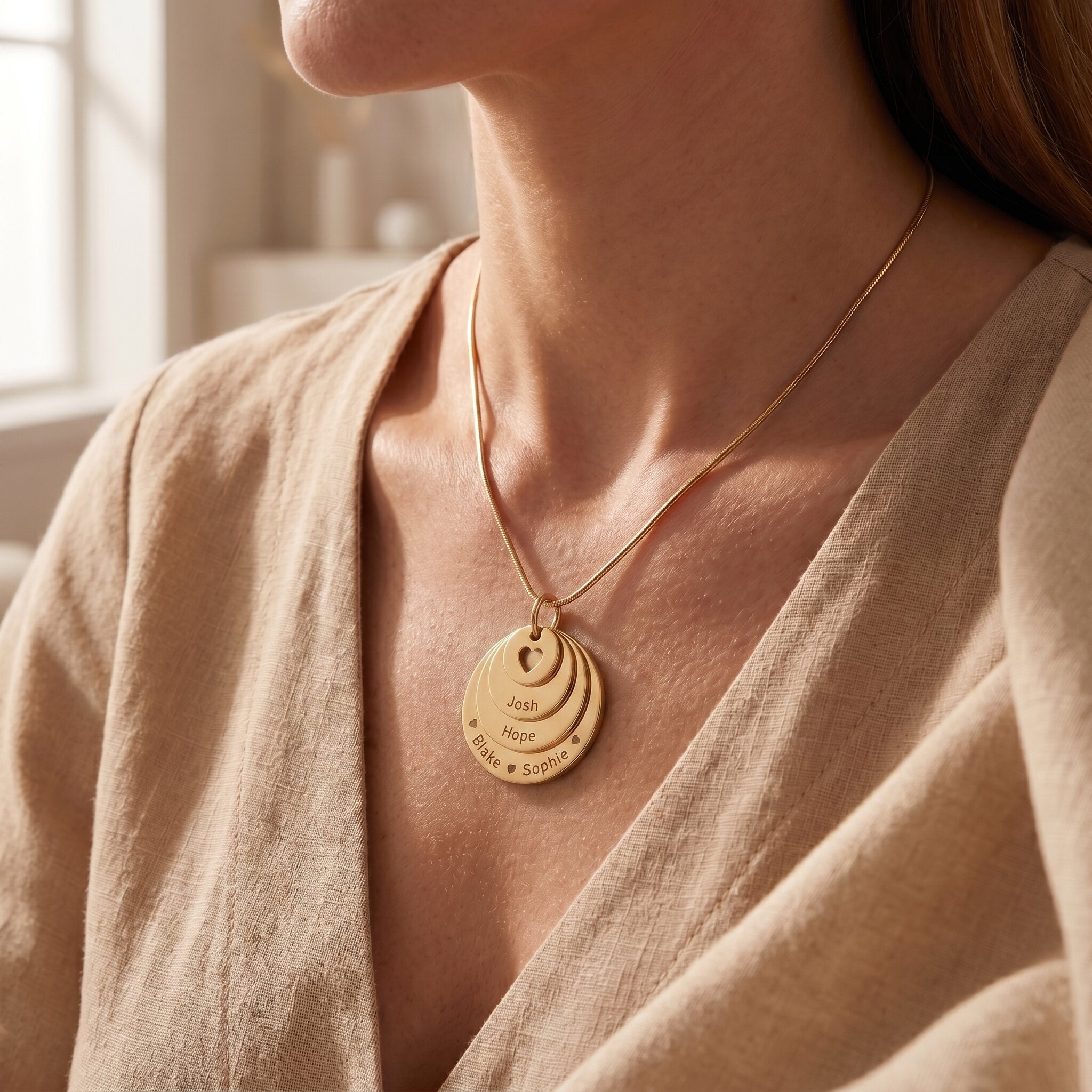 Woman wearing tower of love necklace, layered disc family jewellery and meaningful gift for mum