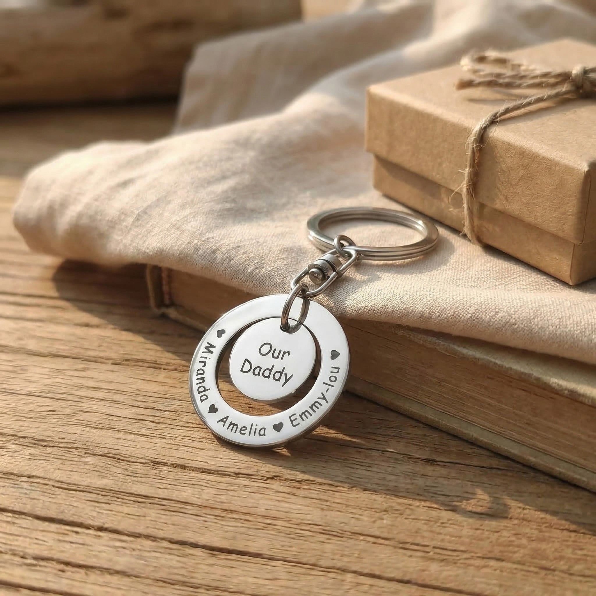 Washer Disc Keyring placed on table with engraved disc and charm, personalised keepsake lifestyle image