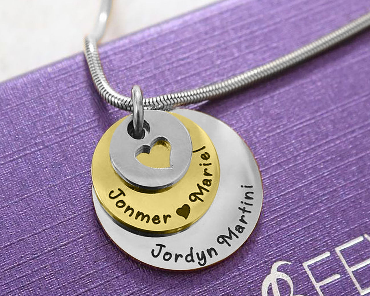 Close-up of two tone  gold Tower of Love necklace with layered round charms, design by Belle Fever Jewellery