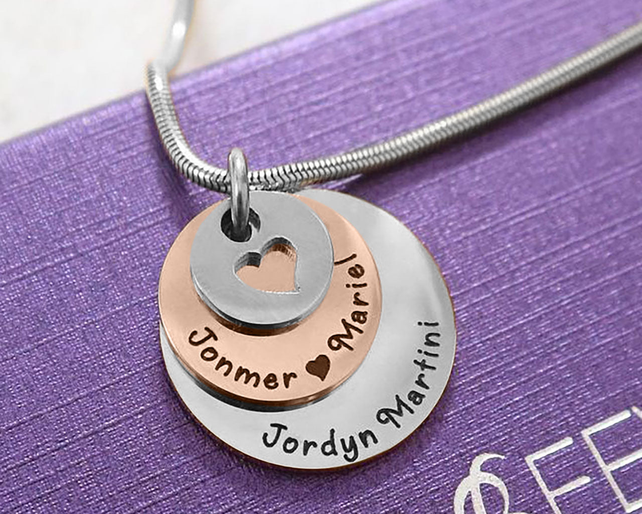 Close-up of the two tone rose gold Tower of Love necklace with layered round charms, design by Belle Fever Jewellery